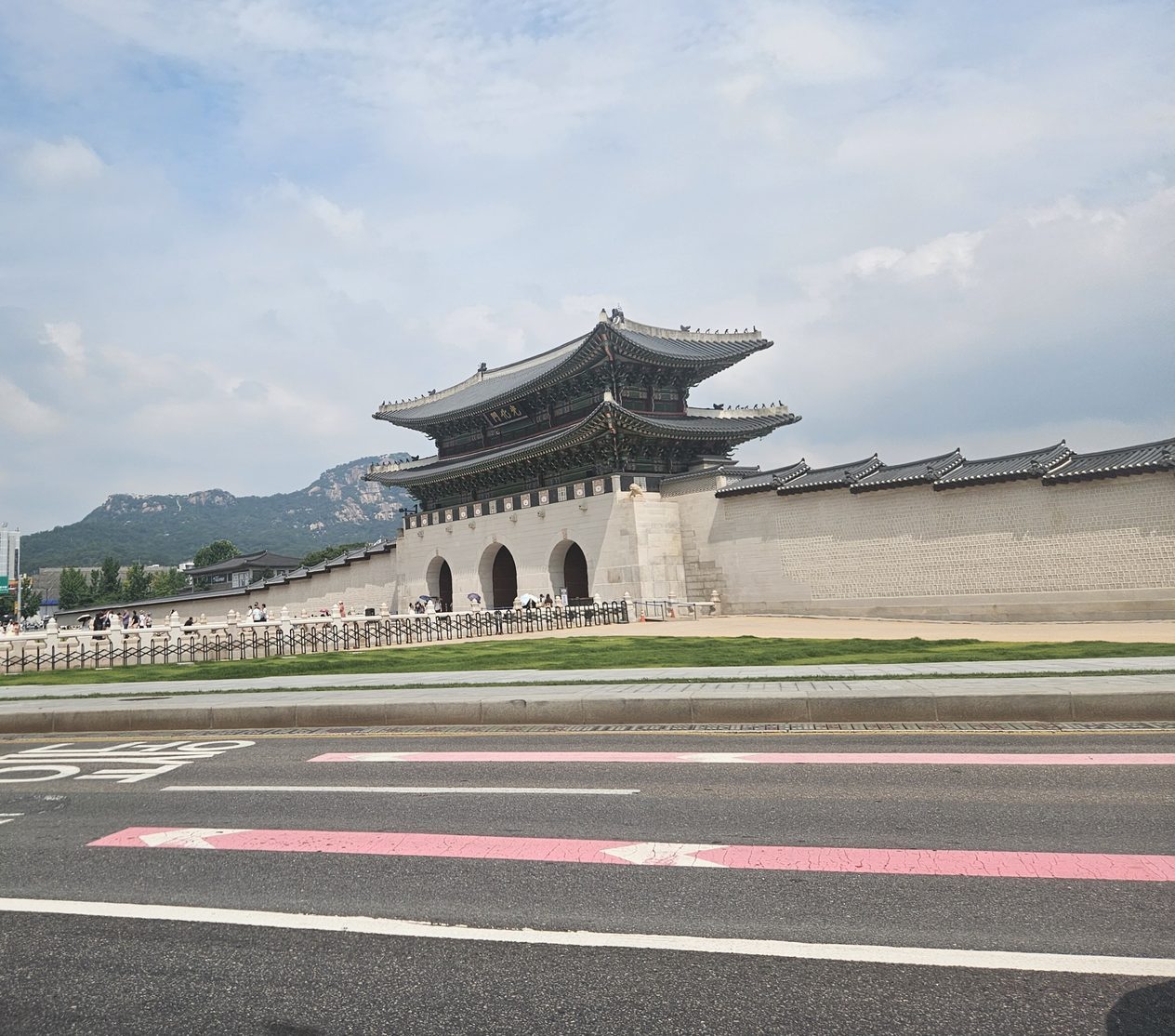 Gwanghwamun, the main gate of Gyeongbokgung Palace in Seoul, seen from across the road with Bugaksan mountain behind it