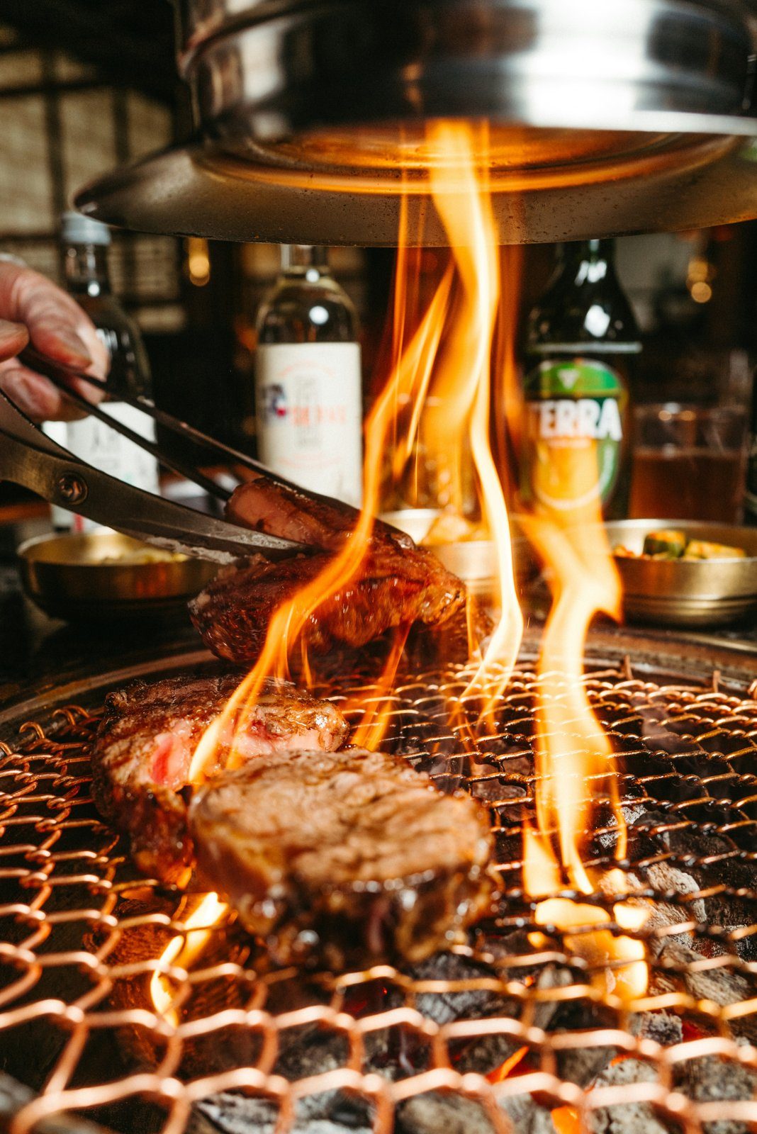 Korean BBQ meat grilling over an open charcoal flame
