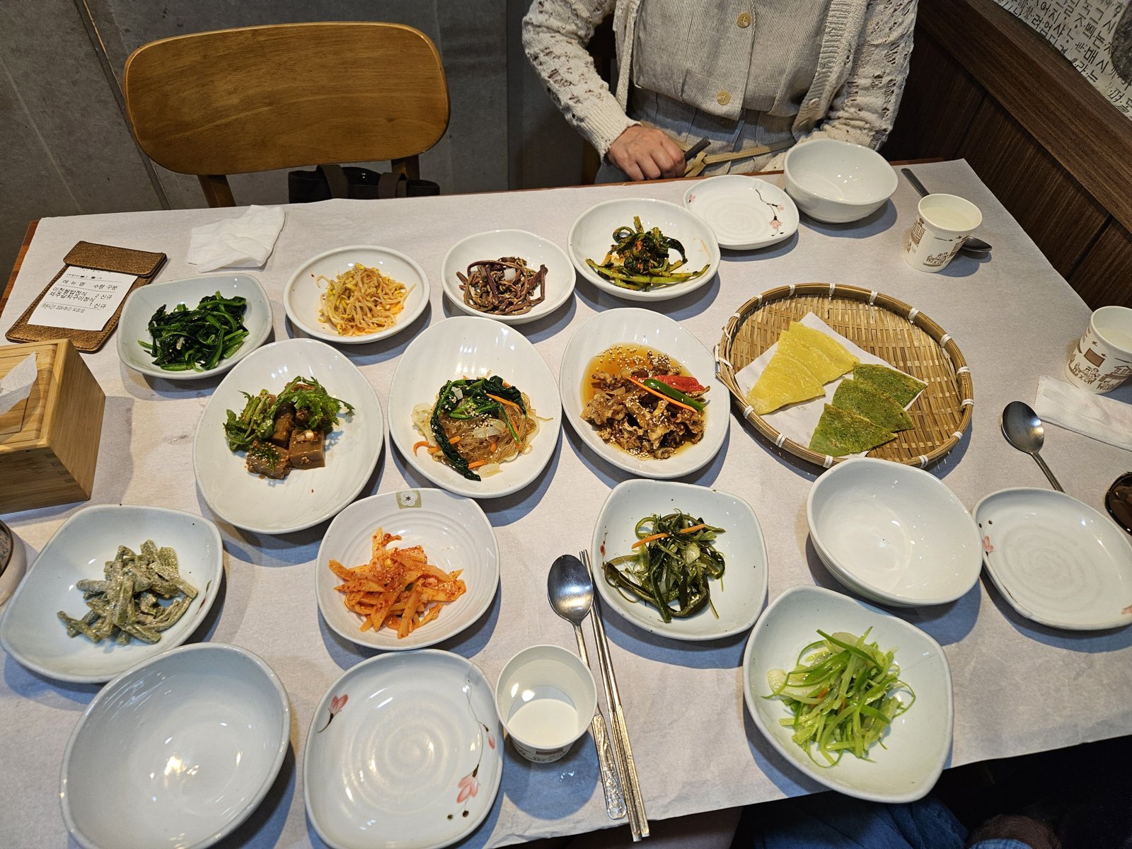 A traditional Korean hanjeongsik table covered with many small banchan side dishes