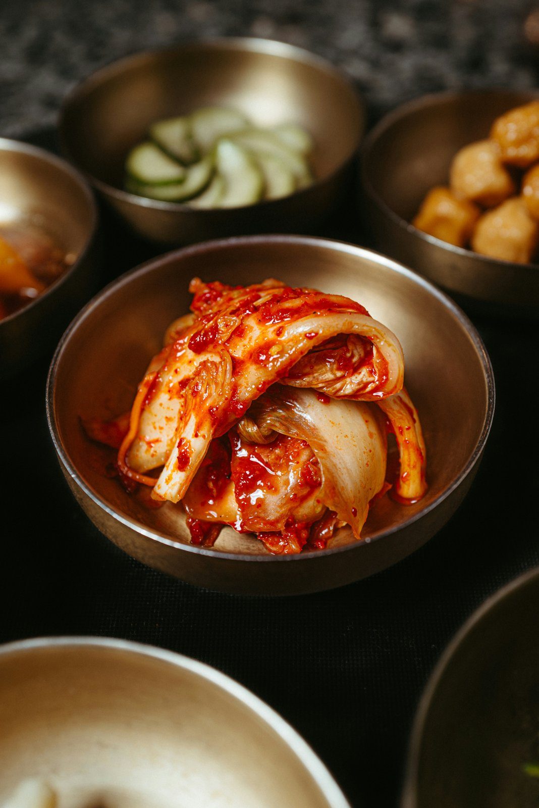 A bowl of kimchi with other Korean banchan side dishes